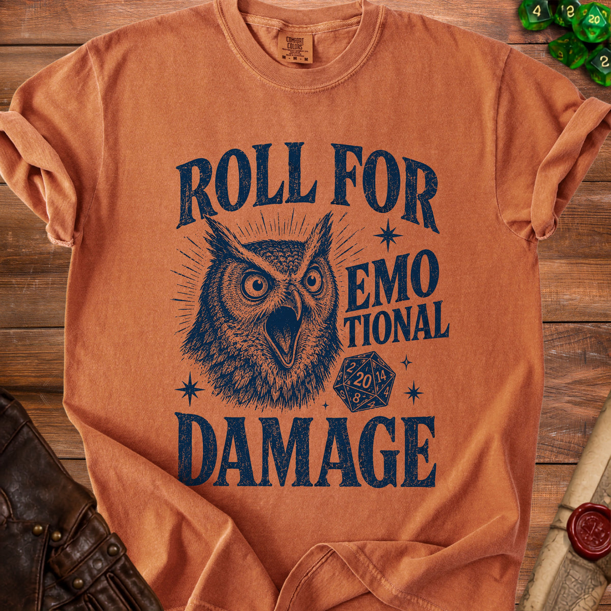 Orange t-shirt with a distressed graphic of an owl and dice, reading "Roll for Emotional Damage".