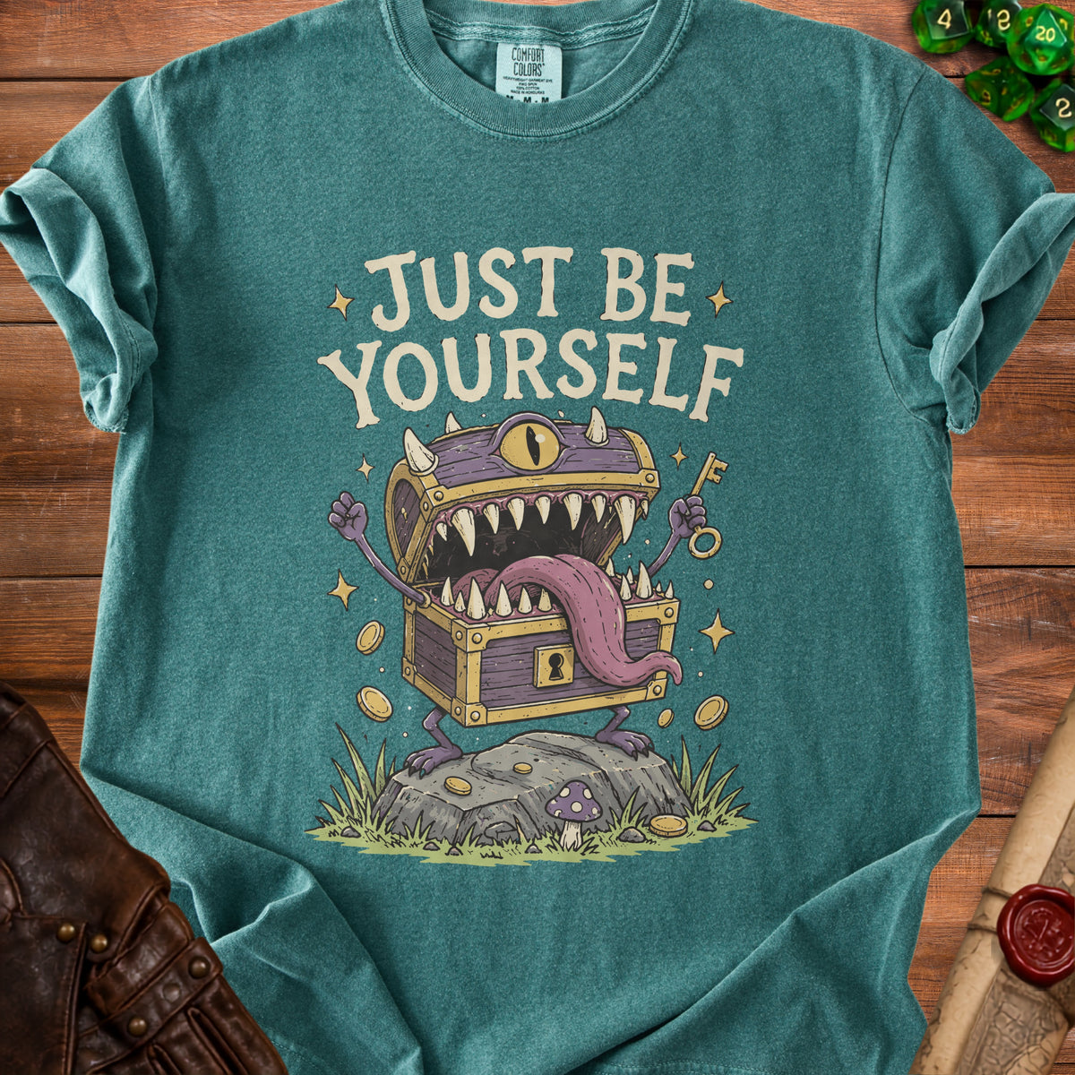 Green t-shirt with "Just Be Yourself" text and a monster treasure chest graphic.