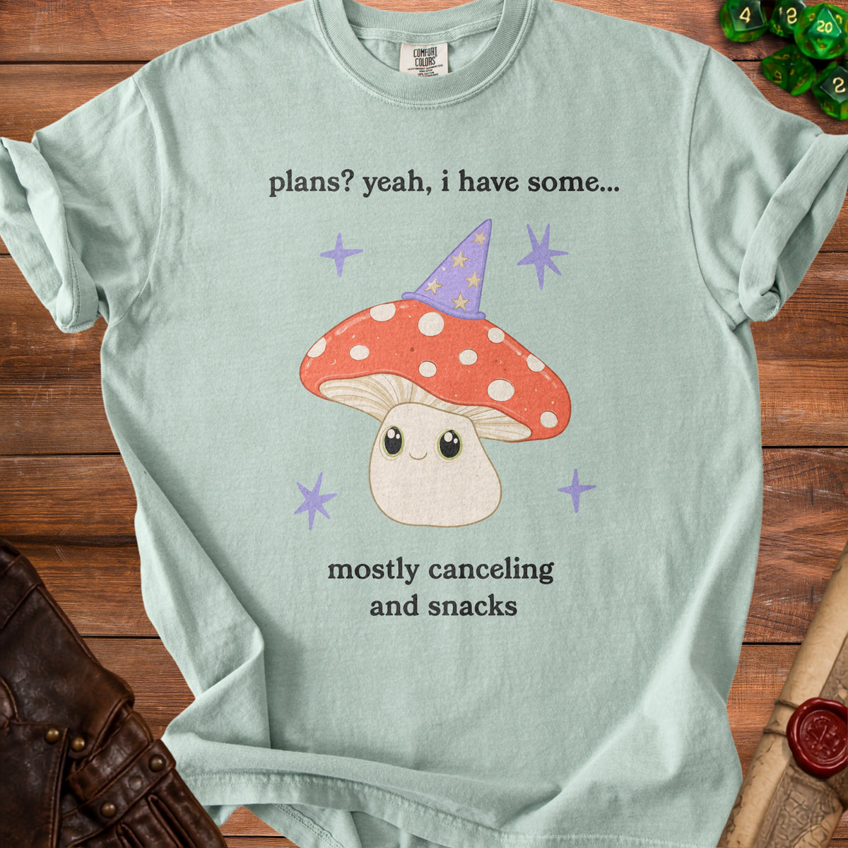 Light blue t-shirt with a cartoon mushroom wearing a wizard hat and text.