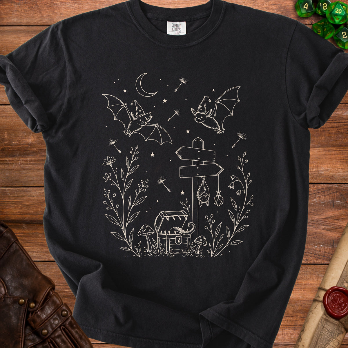 Black t-shirt with a mystical bat, treasure chest, and signpost design.