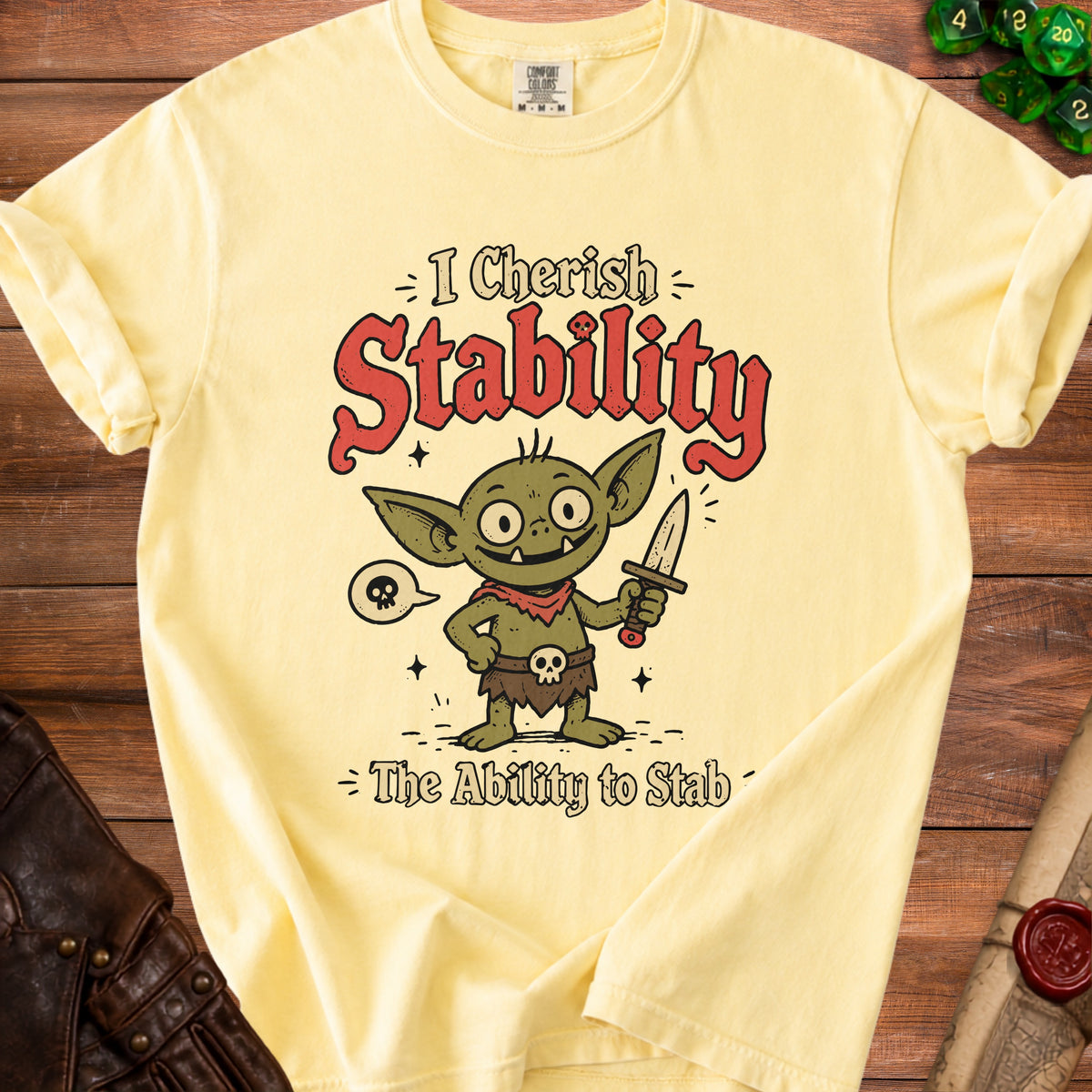 Yellow t-shirt with cartoon goblin and text "I Cherish Stability The Ability to Stab".