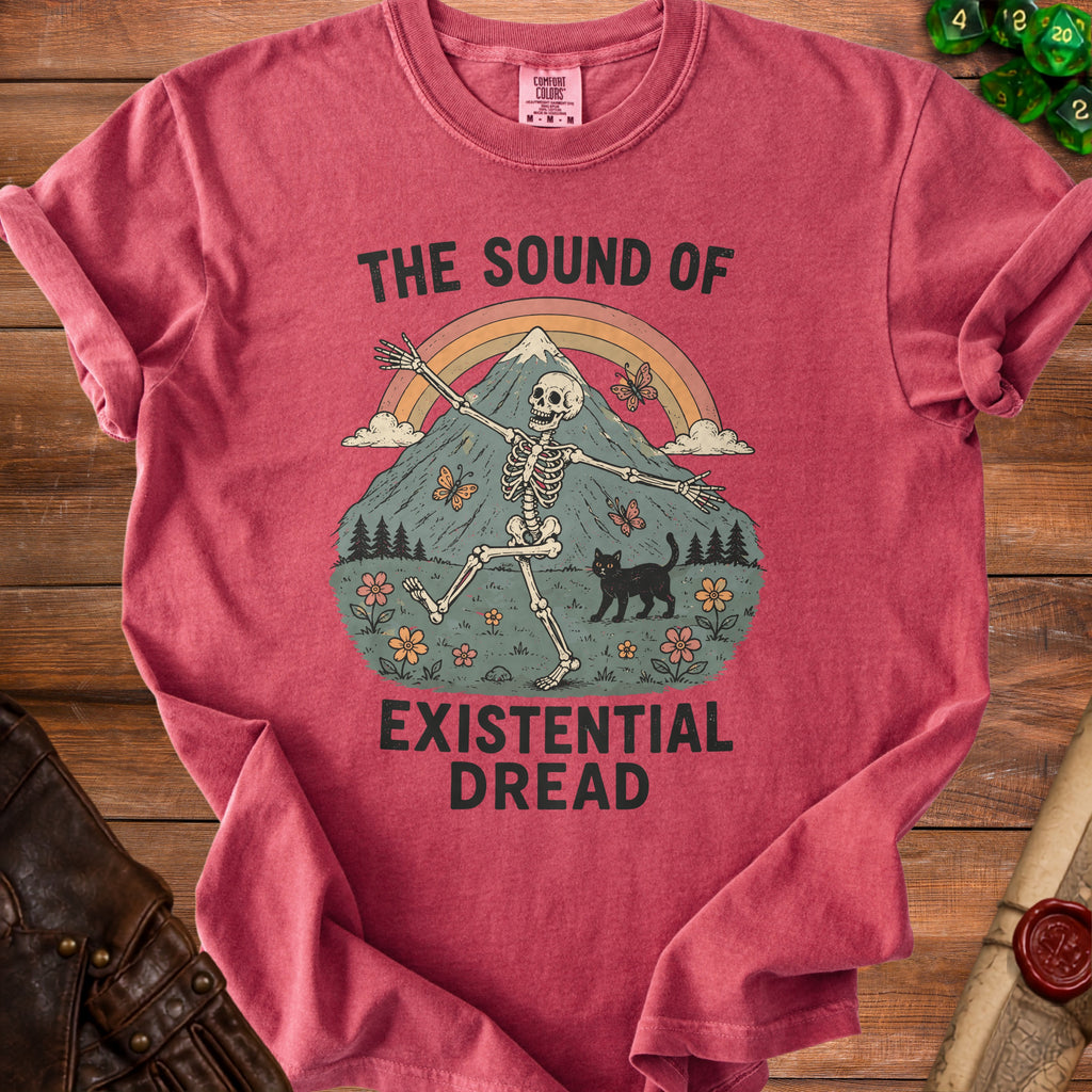 Red t-shirt with skeleton, mountain, rainbow, black cat, butterflies, and text "The Sound of Existential Dread".