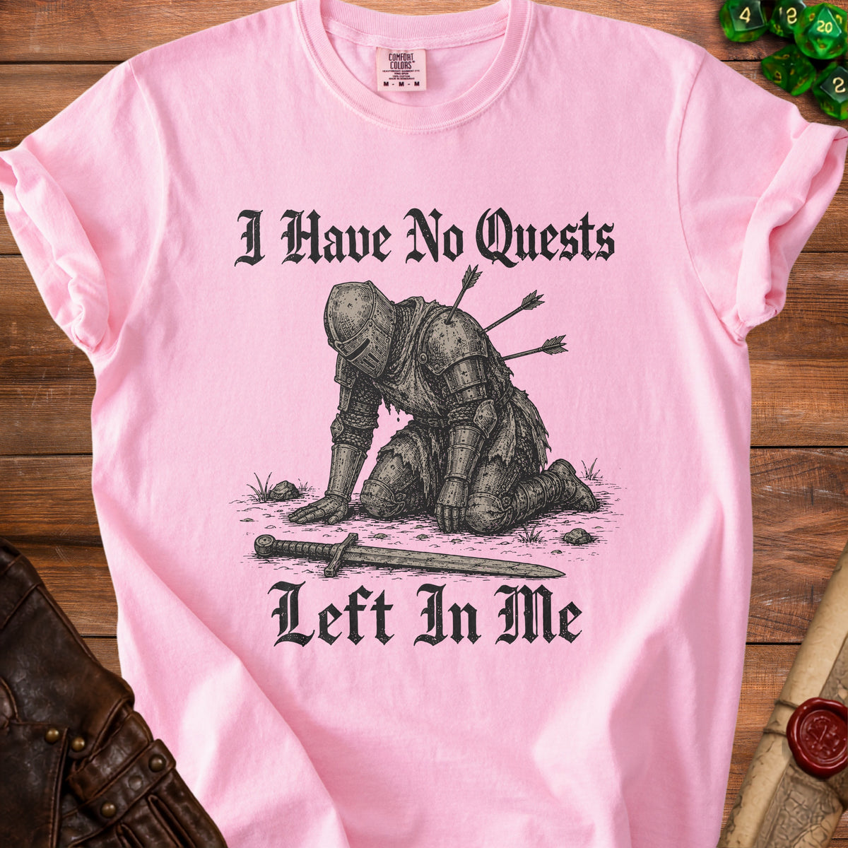 Pink t-shirt with graphic of knight pierced by arrows and text "I Have No Quests Left In Me".