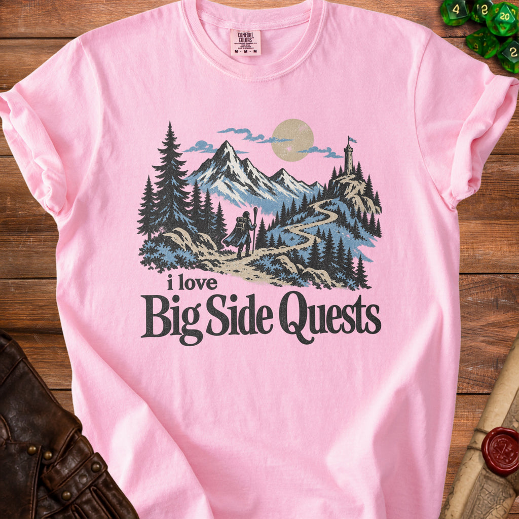 Pink t-shirt with "I love Big Side Quests" and a mountain landscape graphic.
