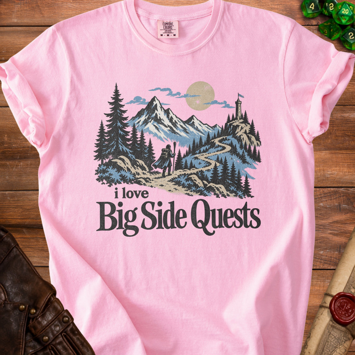 Pink t-shirt with "I love Big Side Quests" and a mountain landscape graphic.