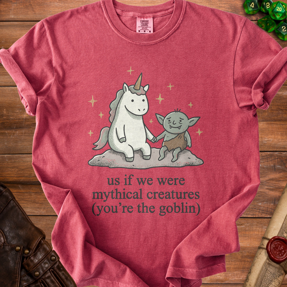 Red t-shirt with unicorn and goblin illustration reading "us if we were mythical creatures (you're the goblin)".