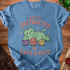 Blue t-shirt with a green cat and dice graphic that reads "Easily Distracted By Cats & Dice".
