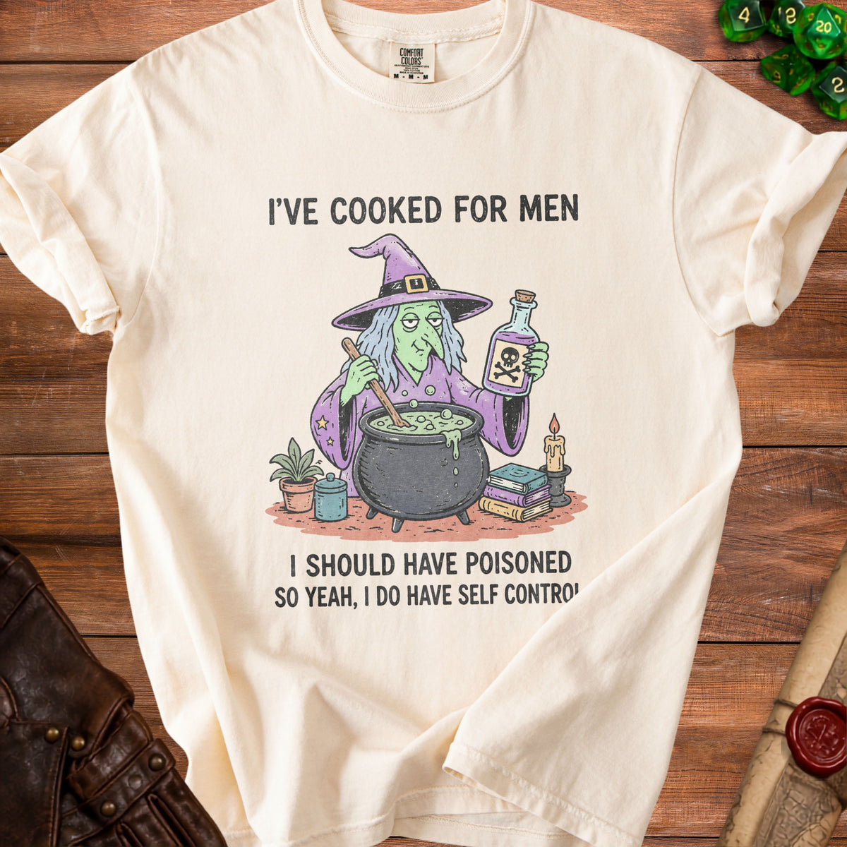 Cream t-shirt with cartoon witch holding poison and stirring a cauldron, text reads "I've cooked for men, I should have poisoned. So yeah, I do have self control."