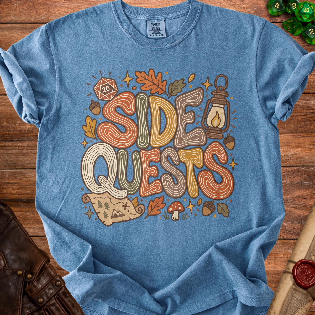 Blue t-shirt with "Side Quests" graphic, dice, lantern, and map.