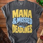 Dark gray t-shirt with yellow and blue text "Mana & Missed Deadlines".