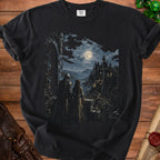 Black t-shirt with fantasy art of knight and woman facing a moonlit castle.