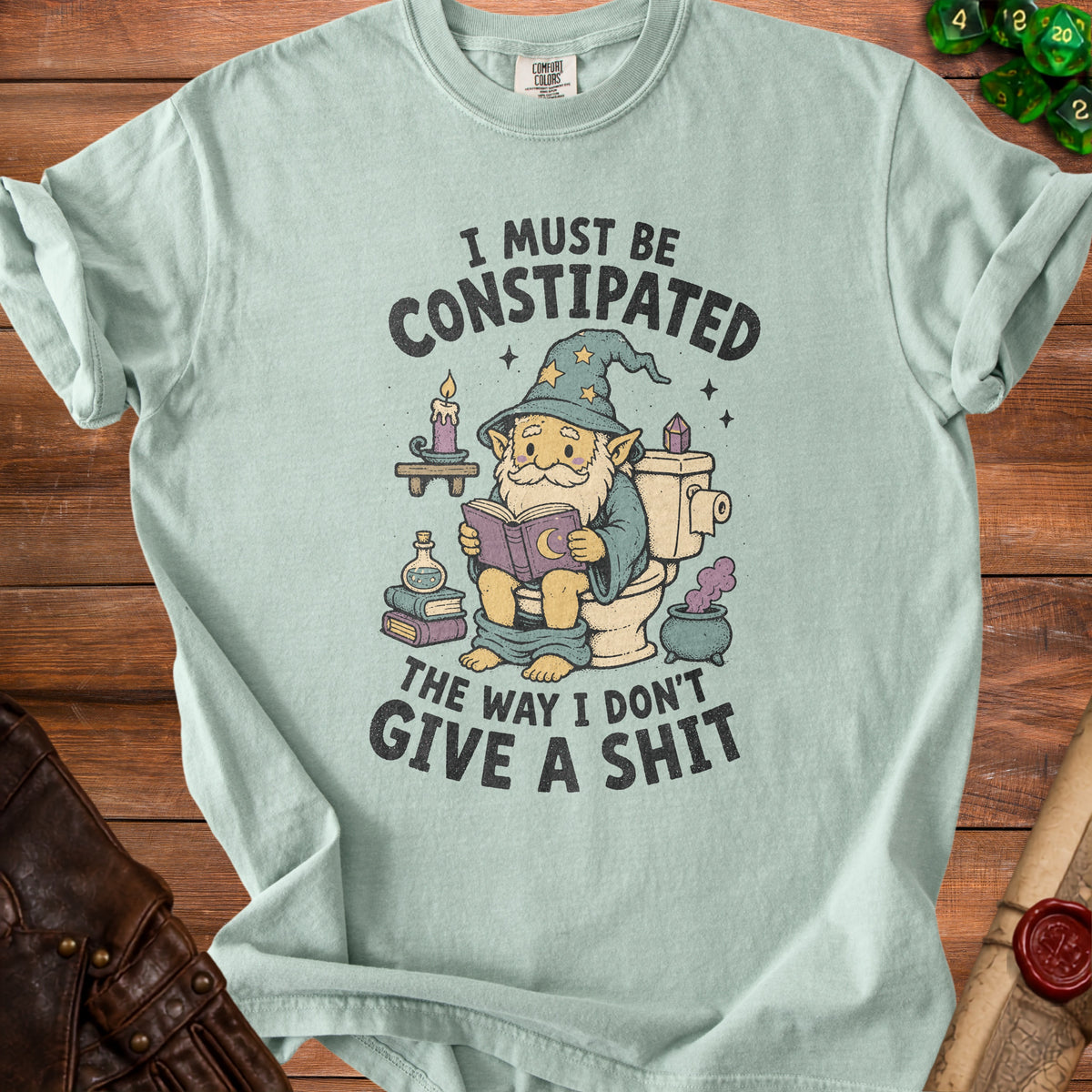 T-shirt with illustration of a gnome on a toilet reading a book and text.