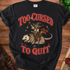 Black t-shirt with red text "TOO CURSED TO QUIT" and goblin riding a possum.