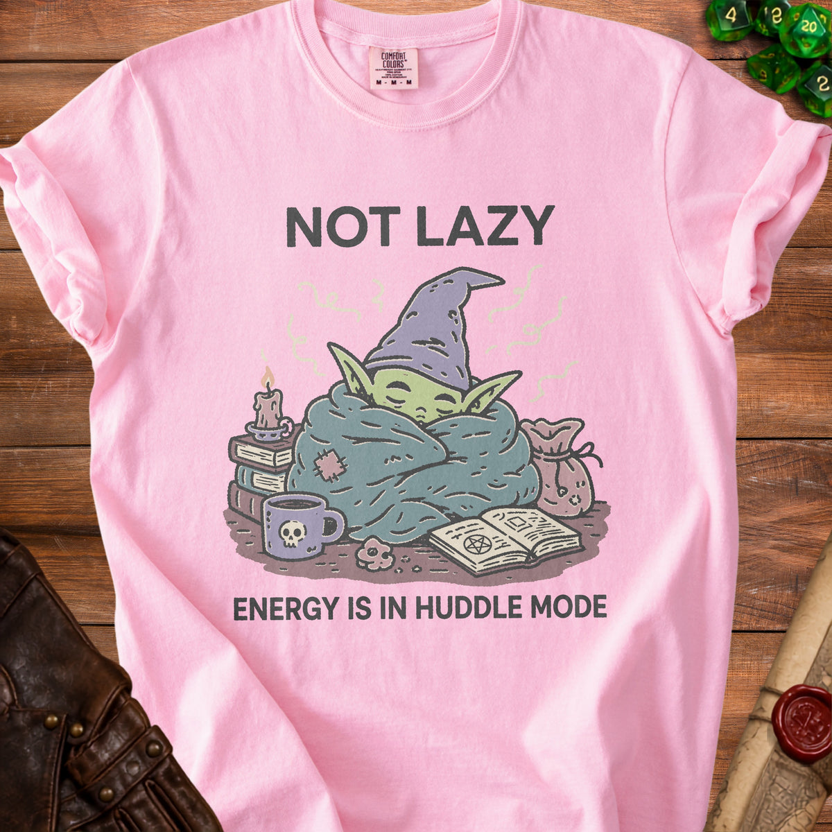 Pink t-shirt with a cartoon wizard character saying "NOT LAZY ENERGY IS IN HUDDLE MODE."