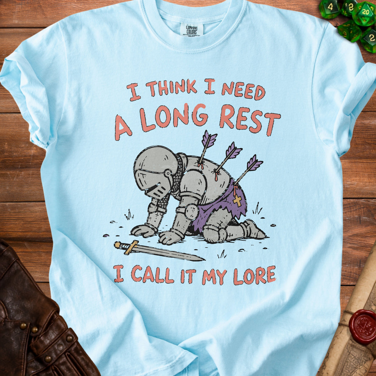 Light blue t-shirt with a knight graphic and text "I THINK I NEED A LONG REST I CALL IT MY LORE."