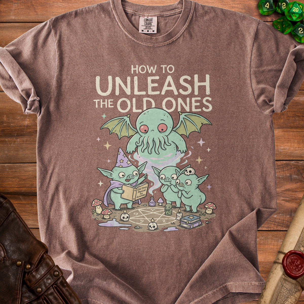 Brown t-shirt with graphic of goblins and Cthulhu reading "Old Ones Manual for dummiez".
