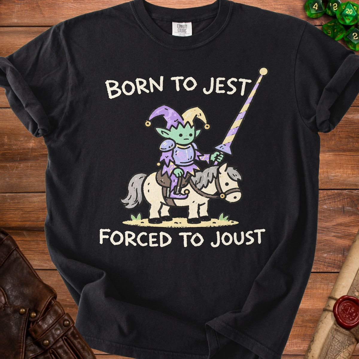Black t-shirt with cartoon goblin jester riding a horse, text "Born to Jest Forced to Joust".