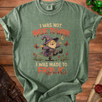 Green t-shirt with gnome graphic and text "I WAS NOT MADE TO WORK I WAS MADE TO FROLIC".