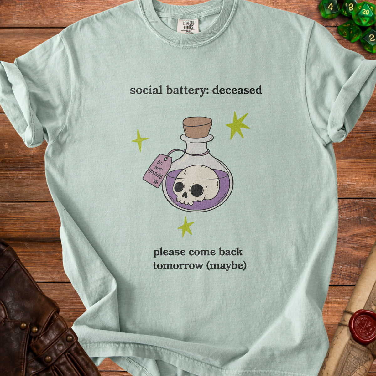 Pale green t-shirt with "social battery: deceased" and potion bottle with skull.