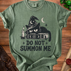 Green t-shirt with a black cat in a witch hat on a book, text reads "DO NOT SUMMON ME".