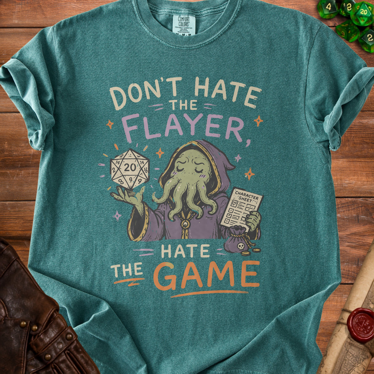 Green t-shirt with text "Don't Hate the Flayer, Hate the Game" and a character.