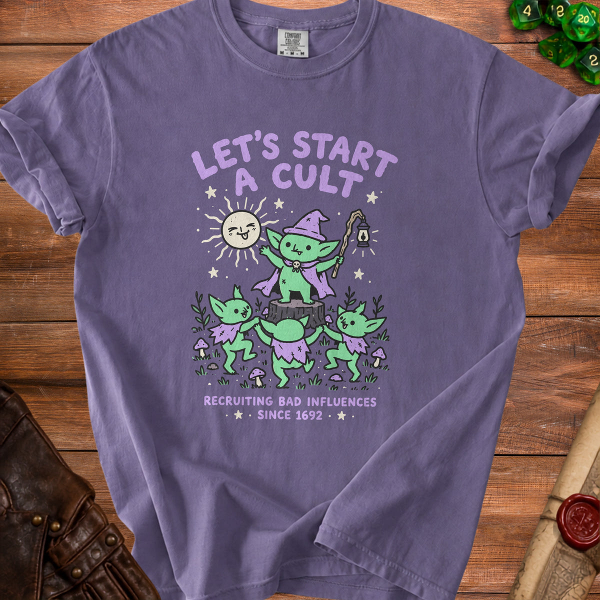 Purple t-shirt with goblins and text "LET'S START A CULT RECRUITING BAD INFLUENCES SINCE 1692".