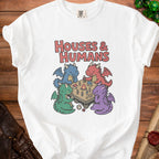 White t-shirt with "HOUSES & HUMANS" text and four cartoon dragons playing a game.