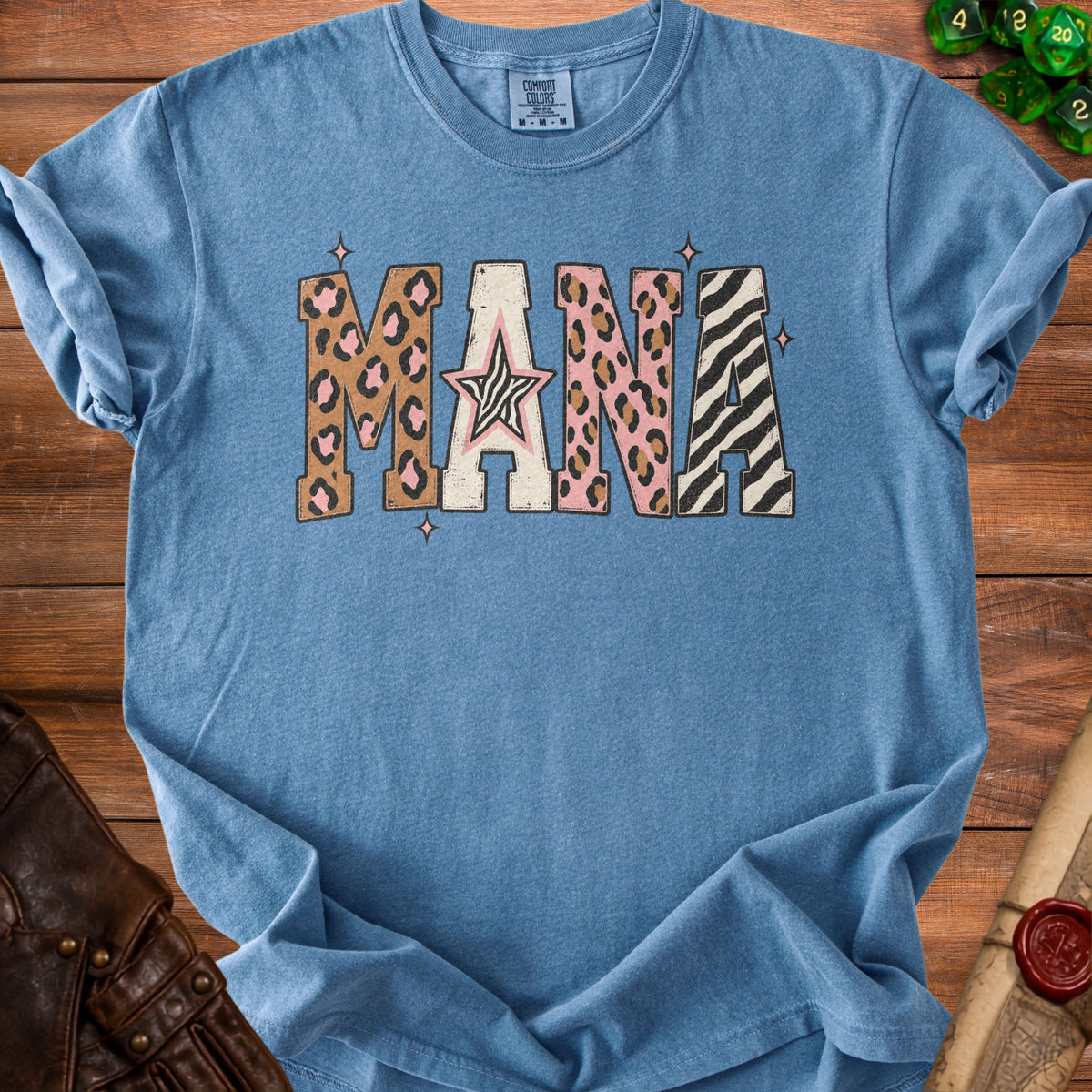 Blue Comfort Colors t-shirt with "MANA" text in leopard and zebra print patterns.