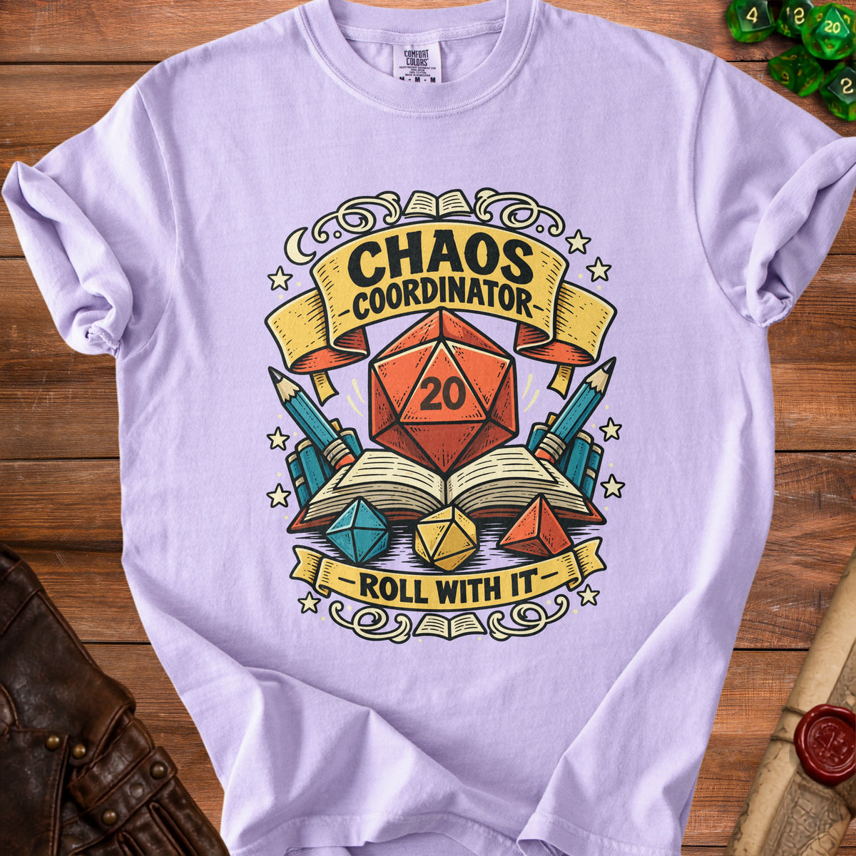 Purple t-shirt with "Chaos Coordinator" and "Roll With It" text and D20 dice graphic.