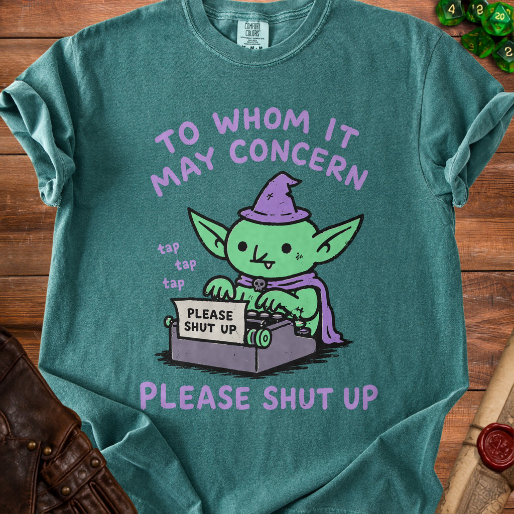 Goblin wearing a witch hat using a typewriter that says "PLEASE SHUT UP".