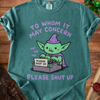 Goblin wearing a witch hat using a typewriter that says "PLEASE SHUT UP".
