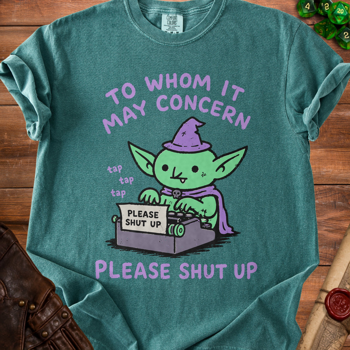 Goblin wearing a witch hat using a typewriter that says "PLEASE SHUT UP".