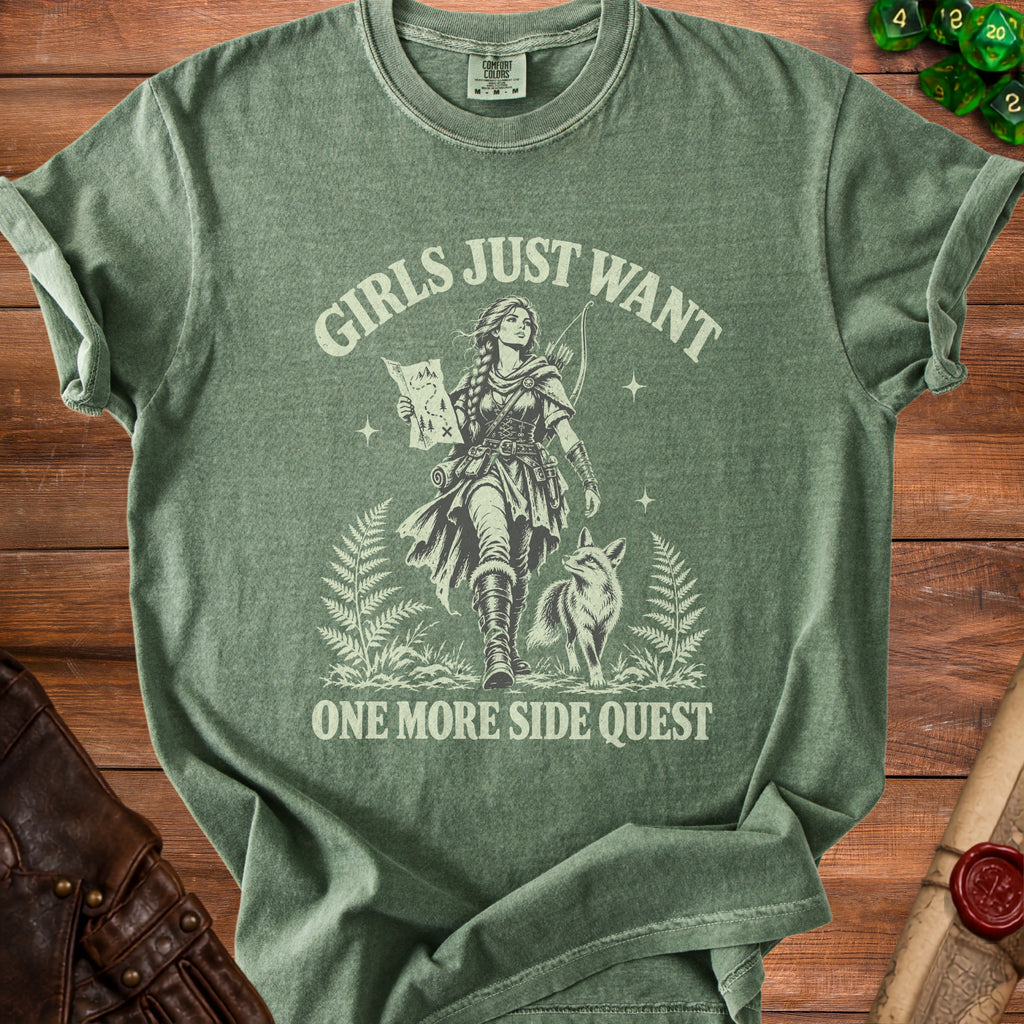 Green t-shirt with a graphic of an archer, fox, and map, reading "Girls Just Want One More Side Quest".