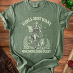 Green t-shirt with a graphic of an archer, fox, and map, reading "Girls Just Want One More Side Quest".