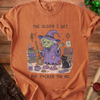 Orange t-shirt with illustration of witch and cat with text "The older I get, the f*cker the no."
