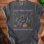 T-shirt with purple hooded figure playing video games and text "I DON'T NEED THERAPY I NEED ANOTHER SAVE POINT".