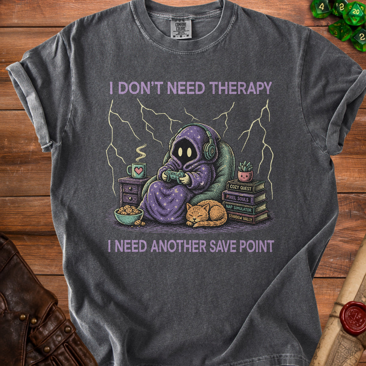 T-shirt with purple hooded figure playing video games and text "I DON'T NEED THERAPY I NEED ANOTHER SAVE POINT".