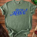 Green t-shirt with "Out of Mana!" text in blue, next to dice and leather gloves.