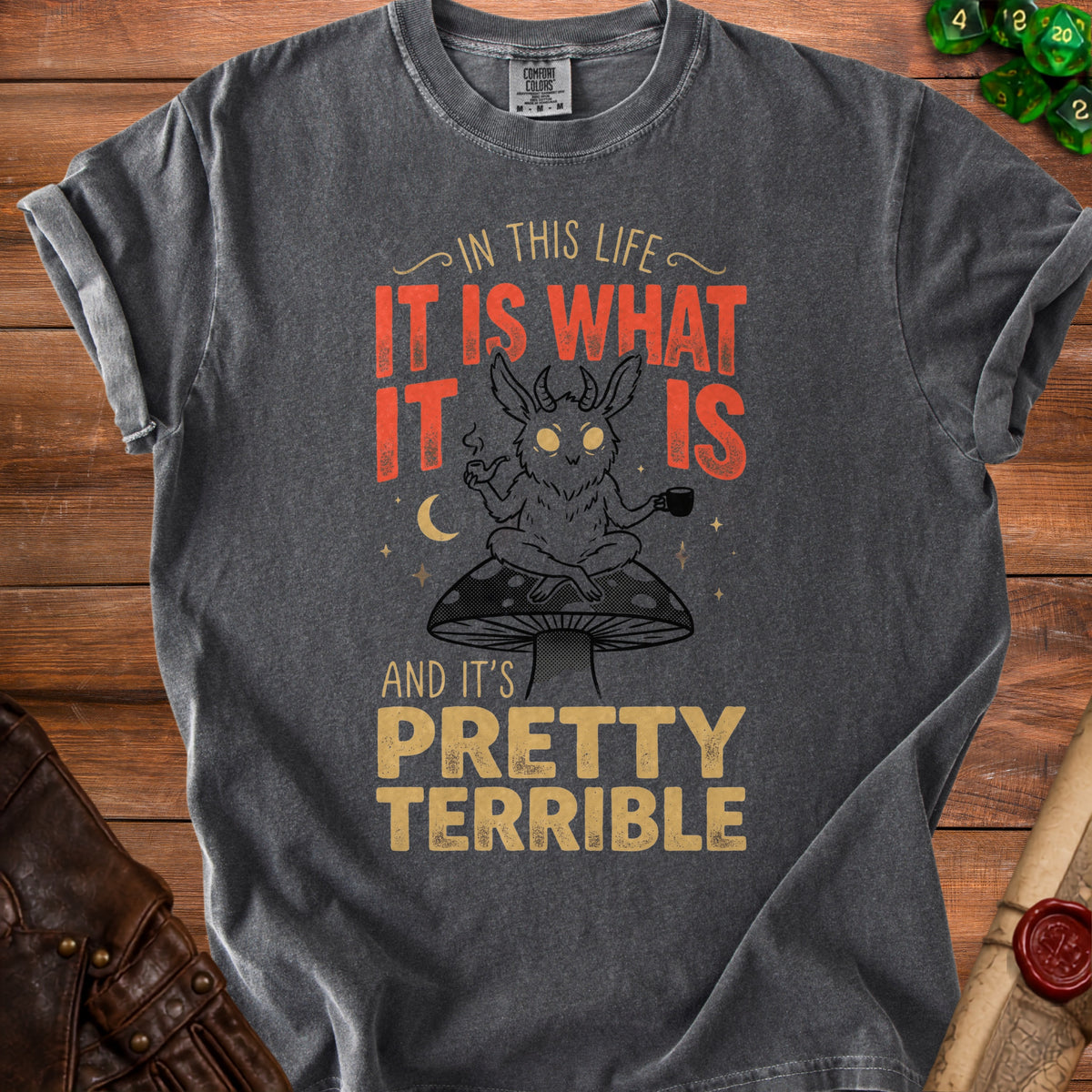 Dark grey t-shirt with illustration of a horned creature sitting on a mushroom, holding a pipe and a mug.