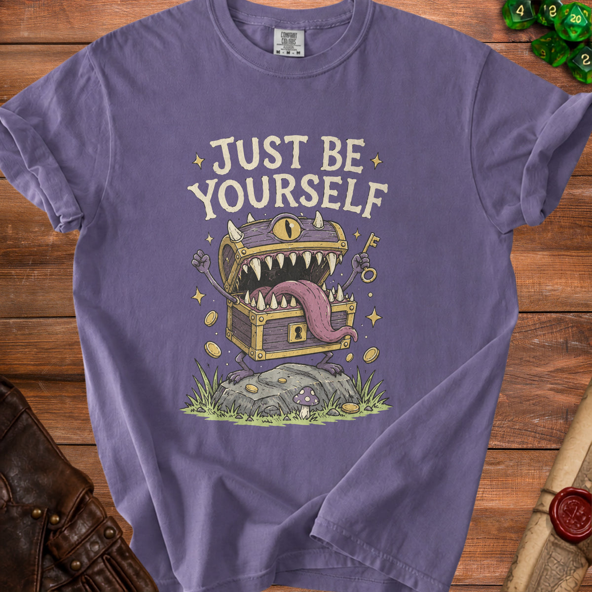 Purple t-shirt with "JUST BE YOURSELF" text and a treasure chest monster graphic.