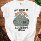 White t-shirt with skeleton, black cat, mountain, rainbow, and butterflies graphic.
