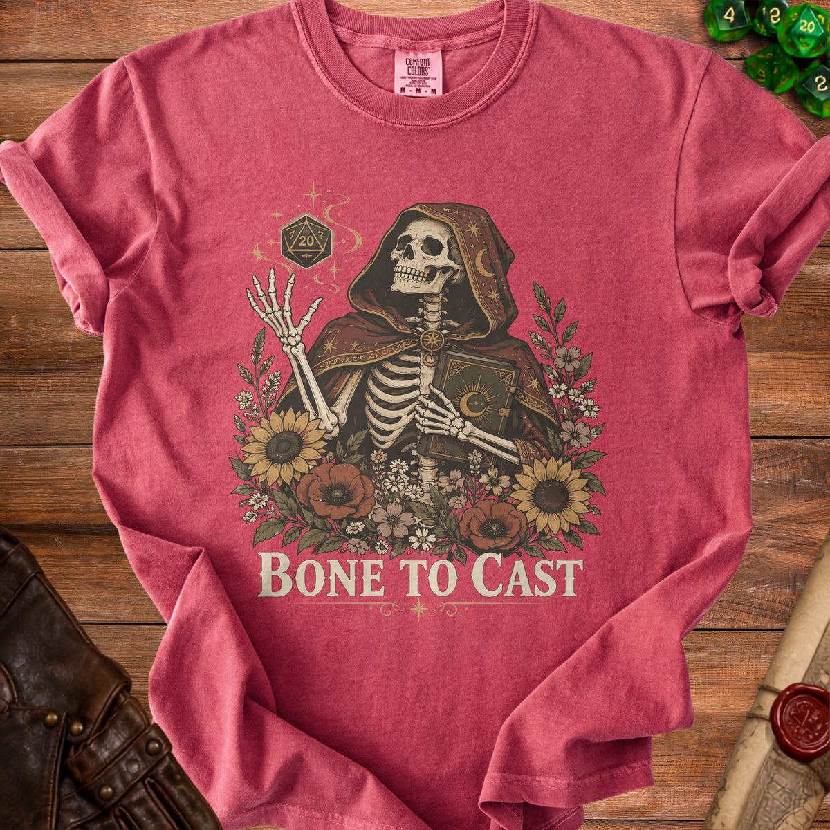 Skeleton wearing a hooded robe holding a book with "BONE TO CAST" text.