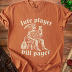 Orange t-shirt with vintage lute player and text "lute player bill payer".