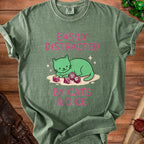 Green t-shirt with a cartoon cat and dice graphic, reading "Easily Distracted by Cats & Dice".