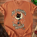 Orange t-shirt with black cat, moon, and "No Thoughts Only Hexes" text.