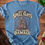 Blue t-shirt with skeleton graphic and text "Out of Spell Slots Still Taking Damage".
