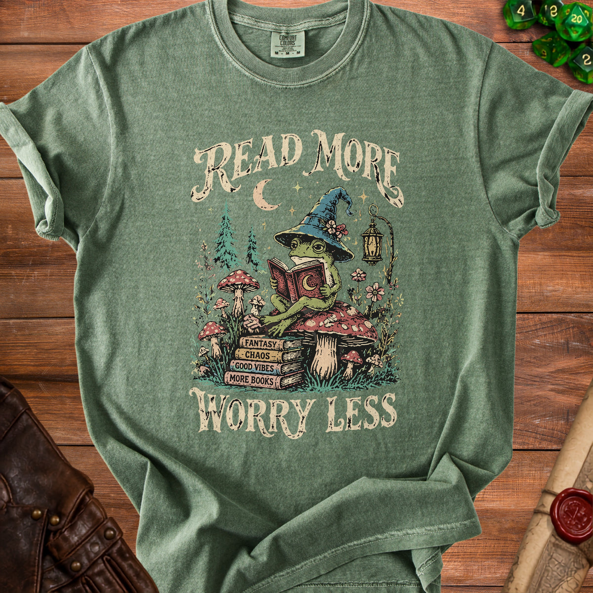 Green t-shirt with a frog wearing a wizard hat reading a book.