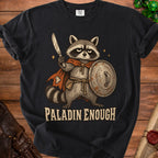 Black t-shirt with a grumpy raccoon warrior holding a sword and shield, text "PALADIN ENOUGH."