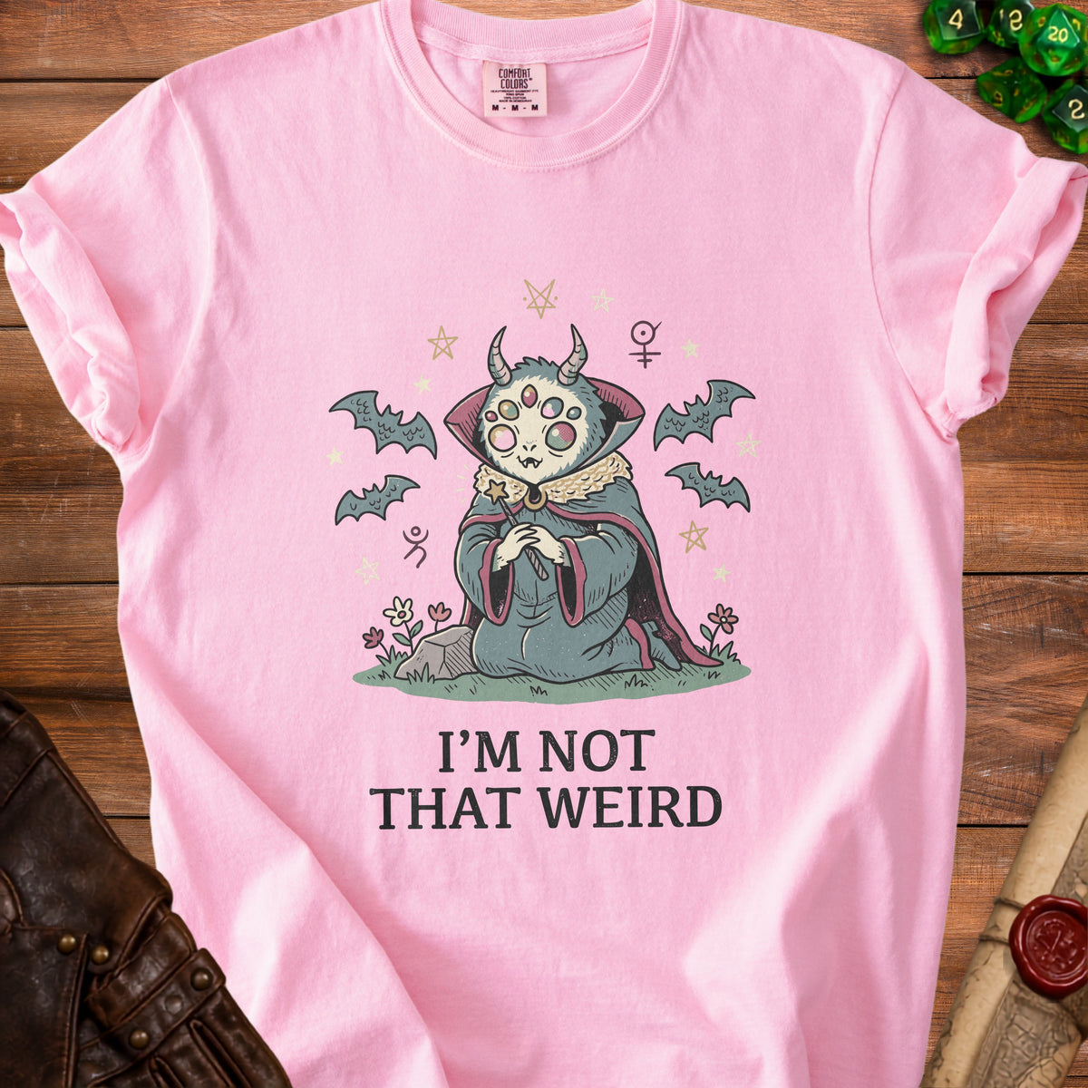 Pink t-shirt with cartoon creature and text "I'M NOT THAT WEIRD".