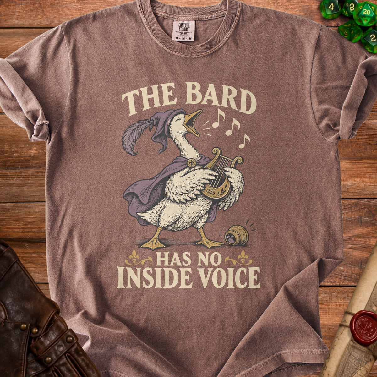 Brown t-shirt with a goose playing a harp and singing, text reads "The Bard Has No Inside Voice".